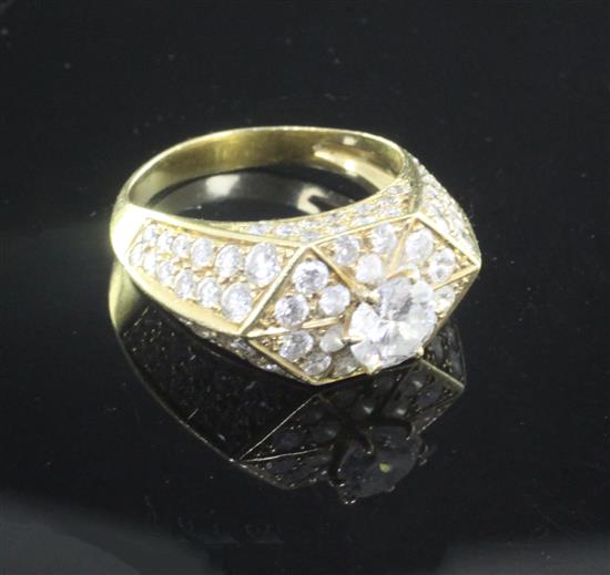 An 18ct gold claw set single stone diamond ring, of hexagonal form, the setting and shoulders set with brilliants, size L.
